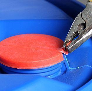 1. First, using plier to clamp one ear of the red plastic cap seal.